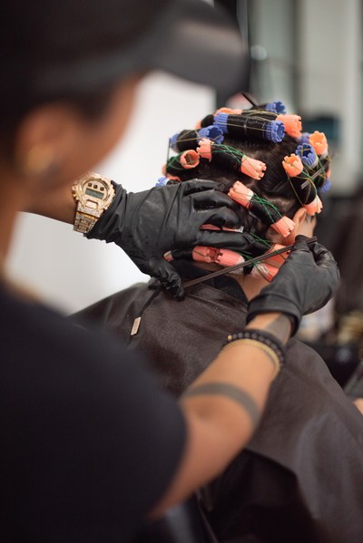 A Salon Fusion stylist setting perm rods