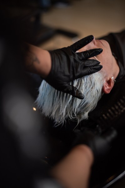A Salon Fusion stylist working on silver hair